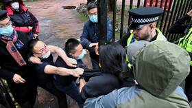 The Chinese consul at Manchester rejects the British accusations against him by beating a protester