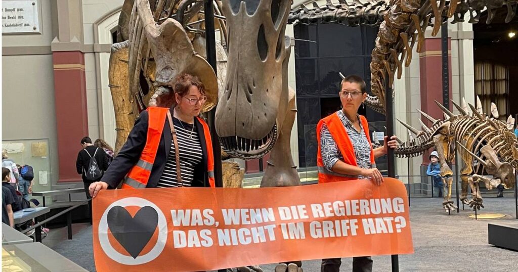 German climate activists glue themselves to dinosaur display