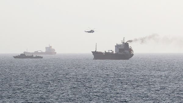 A journey plane hovering over a ship in the Gulf of Oman