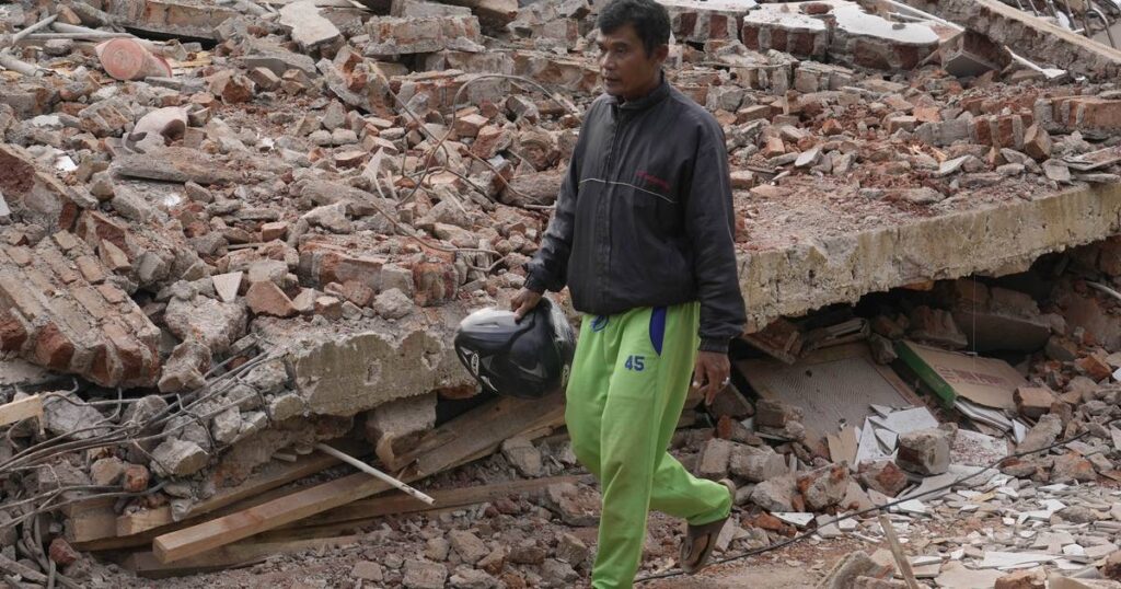 Indonesia quake survivor grieves 11 relatives as he rebuilds